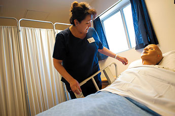 Verna Cly-Begay practices making a bed during her nursing class at Navajo Technical College. The program, which is in it's first semester of classes, is proving to very popular among students. © 2011 Gallup Independent / Brian Leddy
